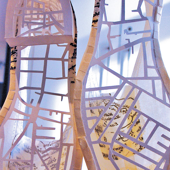 Laser cut paper shoes incorporating maps showing the shoe making district of Northampton by Cabinet of Curiosity Studio for a Cultural Olympiad commission and exhibition at Northampton Museum and Art Gallery