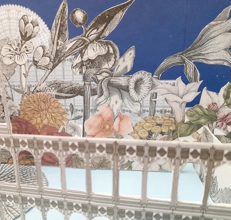 Decorative design with flowers, leaves, and a decorative frame on a blue background